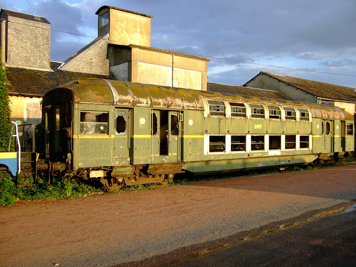 Une voiture à étage État fortement dégradée, vue ici à Richelieu sur le réseau disparu du Train à Vapeur de Touraine (TVT).